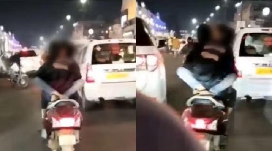 Lucknow : Girl sitting on boy's lap on moving scooty, kissing video goes viral, action taken 