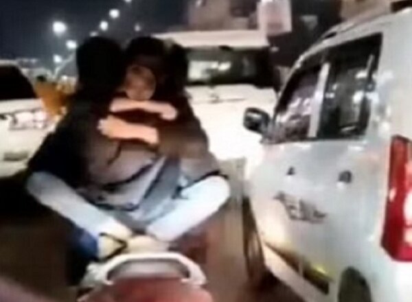 Lucknow : Girl sitting on boy's lap on moving scooty, kissing video goes viral, action taken