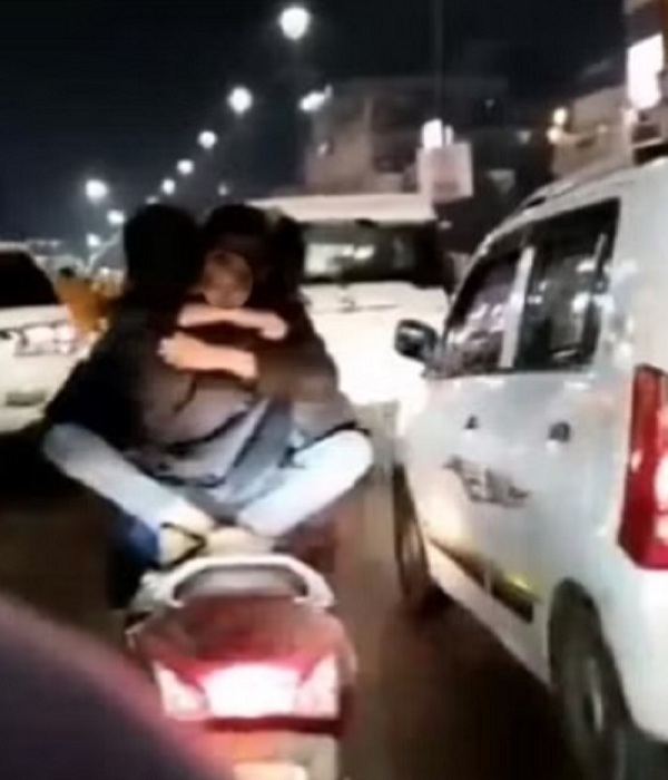 Lucknow : Girl sitting on boy's lap on moving scooty, kissing video goes viral, action taken